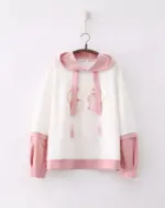 White sakura bunny hoodie with pink trim, featuring an embroidered bunny pair on the chest. A harajuku aesthetic.