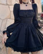 Black french aesthetic dress with lace details, puff sleeves, and a corset closure.