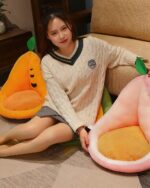 Two kawaii fruit cushions - an orange pineapple and a pink strawberry - shown as seat cushions.