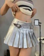 Silver pleated skirt with a metallic sheen and belt detail.
