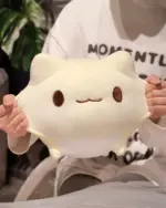 Close-up of a white round neko plushie with visible eyes and mouth.