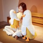 Two banana duck plushies displayed with a person. A cute banana duck plushie.