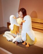 Two banana duck plushies displayed with a person. A cute banana duck plushie.