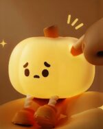 Cute pumpkin night light, a soft silicone lamp with a smiling face and stem.