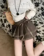 Laced pleated korean aesthetic skirt with a gathered waistband and tie closure.