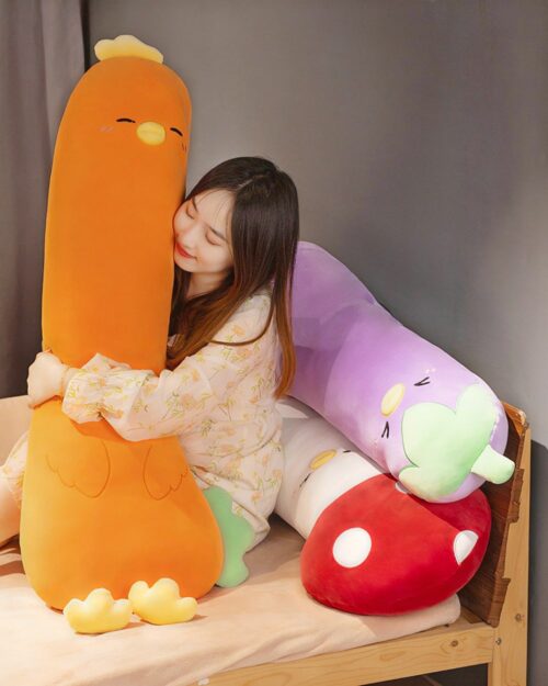 A person hugging a long vegetable plushie (long vegetable plushie) and another plush mushroom.