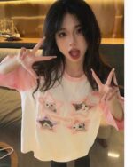 Model wearing a Kitty Pink T-Shirt featuring cat illustrations, Kawaii Clothes.