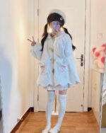 Model wearing a fluffy rabbit ears hoodie, kawaii style clothing.