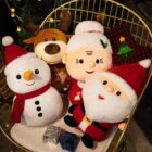 Christmas plushie decor featuring a snowman, reindeer, and Santa Claus in a decorative basket.
