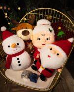Christmas plushie decor featuring a snowman, reindeer, and Santa Claus in a decorative basket.