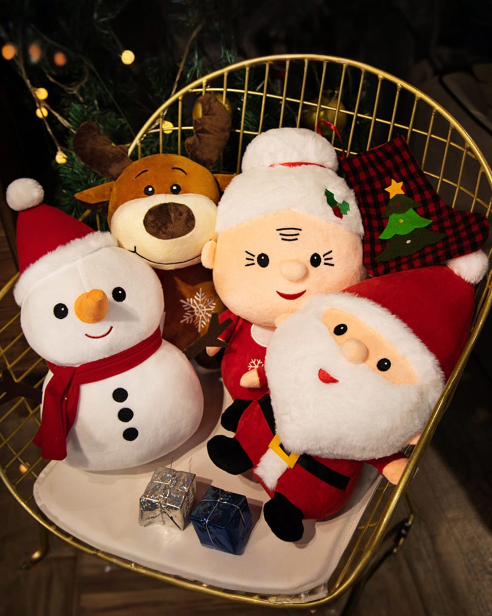 Christmas plushie decor featuring a snowman, reindeer, and Santa Claus in a decorative basket.