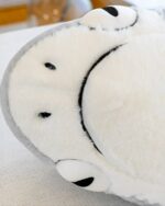 Close-up of Fins the Chonky Shark, a giant shark plushie, showcasing its soft texture and features.