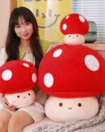 Two red giant mushroom plushies, a chonky plush toy, with white spots and cute faces.
