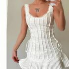 White pleated tied dress, coquette aesthetic dress with lace accents and a fitted bodice.