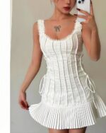White pleated tied dress, coquette aesthetic dress with lace accents and a fitted bodice.