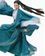 Embroidered jade hanfu in teal with gold embroidery, depicting a figure in traditional Chinese attire.
