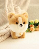 Close-up of a brown puppy collectible plush toy with a small pink nose and a golden tag.