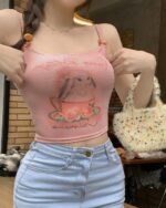 Pink bunny aesthetic top with a tea illustration, cropped view.