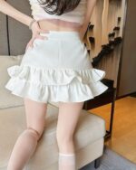 High-Waist Ruffled Mini Skirt - Korean Aesthetic, showcasing a light-colored, ruffled mini skirt with a high waist.