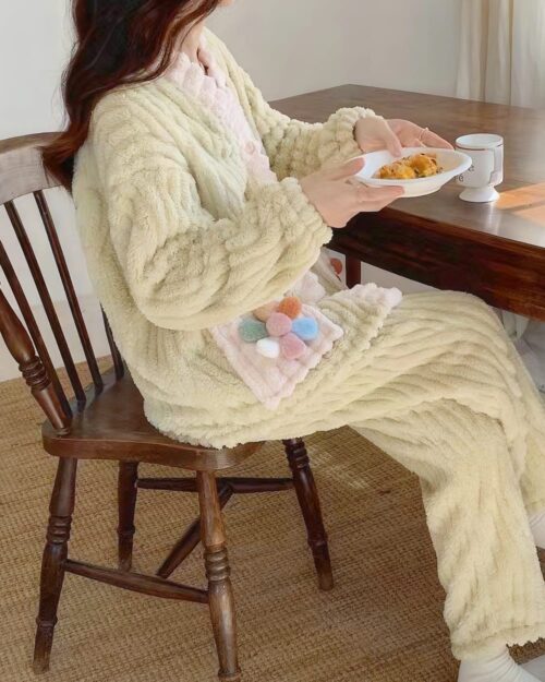 Close-up of thick kawaii plush pajamas featuring a textured design and pom-poms.