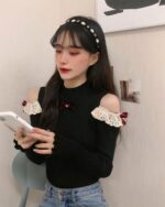 Black coquette aesthetic top with lace sleeves and a high neck.