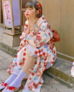 Woman wearing a retro checkered kimono with floral details, Japanese aesthetic style.