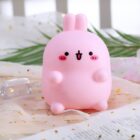 Pink molang bunny lamp on a patterned surface, soft lighting.