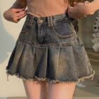 Gray denim y2k aesthetic skirt with pleats and frayed edges.
