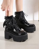 Black gothic leather boots with a platform sole and bat wing detailing.