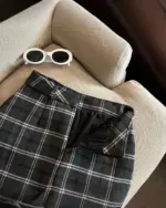 Close-up of a grey and white plaid mini skirt, embodying a preppy aesthetic skirt style.