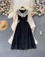 Black puff sleeve french aesthetic dress, featuring a high collar and full skirt.