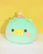 Kawaii Cozy Plushie Handwarmer featuring a mint green pig with a party hat and black eyes. Adorable plushie.