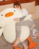 Kawaii duck plushie, Winston the Duck, resting on a patterned blanket.