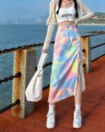 Colorful y2k denim skirt with tie details and fringe trim, worn with sneakers.