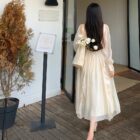 Woman wearing a French Style Long Sleeve Dress, coquette aesthetic dress, outdoors.