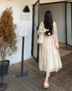 Woman wearing a French Style Long Sleeve Dress, coquette aesthetic dress, outdoors.