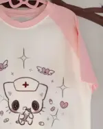 Pink neko nurse t-shirt with kawaii illustrations, including a cat nurse and stars.