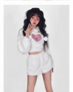 A white kawaii fluffy pajamas set featuring a hooded top and shorts, worn by a model.