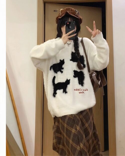 White kitten sweater with embroidered black cat figures. Kawaii clothes.