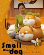 Extra Chonky Shiba Inu plush toy displayed with a person, soft and cuddly design.
