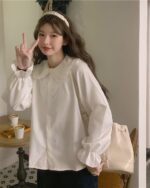 White vintage aesthetic shirt with a frilled collar and puff sleeves, featuring a coquette fashion style.