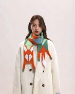 Woman wearing a cute fox scarf with a cottage aesthetic design. Fox scarf product.