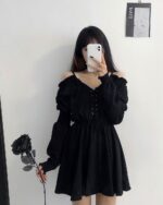 Solid black gothic aesthetic dress worn by a person, featuring long sleeves and off-shoulder detailing.