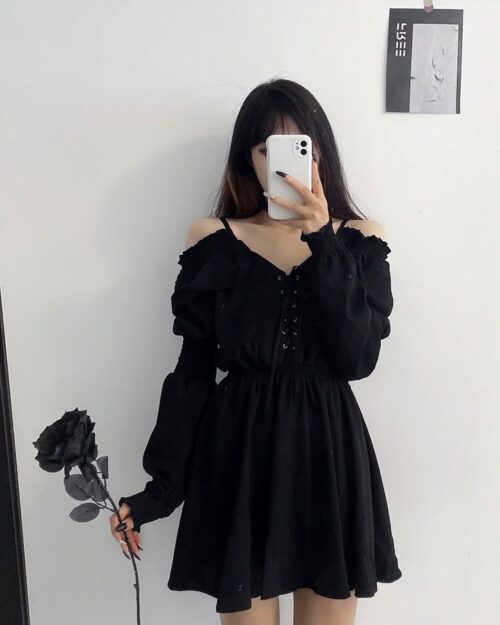 Solid black gothic aesthetic dress worn by a person, featuring long sleeves and off-shoulder detailing.