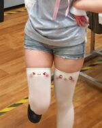 Kawaii Collection kaomoji cute stockings featuring embroidered emoticons on white thigh-highs.