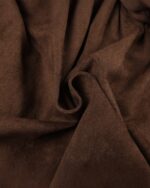 Close-up of aesthetic vintage skirt fabric, a rich brown suede texture.