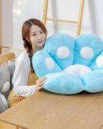 Kawaii neko pillow, a blue plush paw-shaped cushion with white accents, shown with a person.