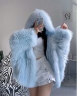 Light blue puffy hooded coat with a large hood, winter fashion.