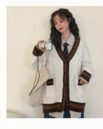 White knitwear loose cardigan with brown stripes, preppy aesthetic style.