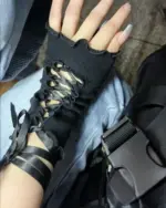 Black gothic fishnet gloves with lace-up detailing, featuring a fingerless design.